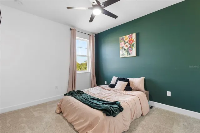 a bedroom with a bed and window