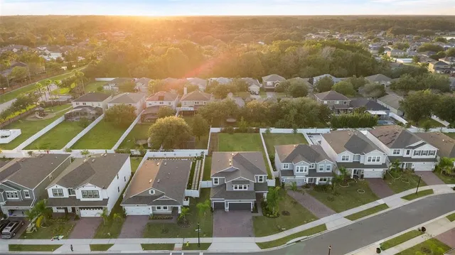 an aerial view of houses with a lake