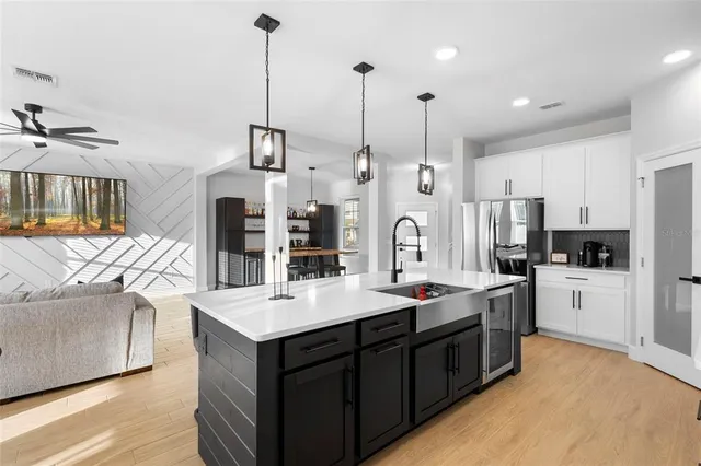a large kitchen with kitchen island a sink stainless steel appliances and cabinets