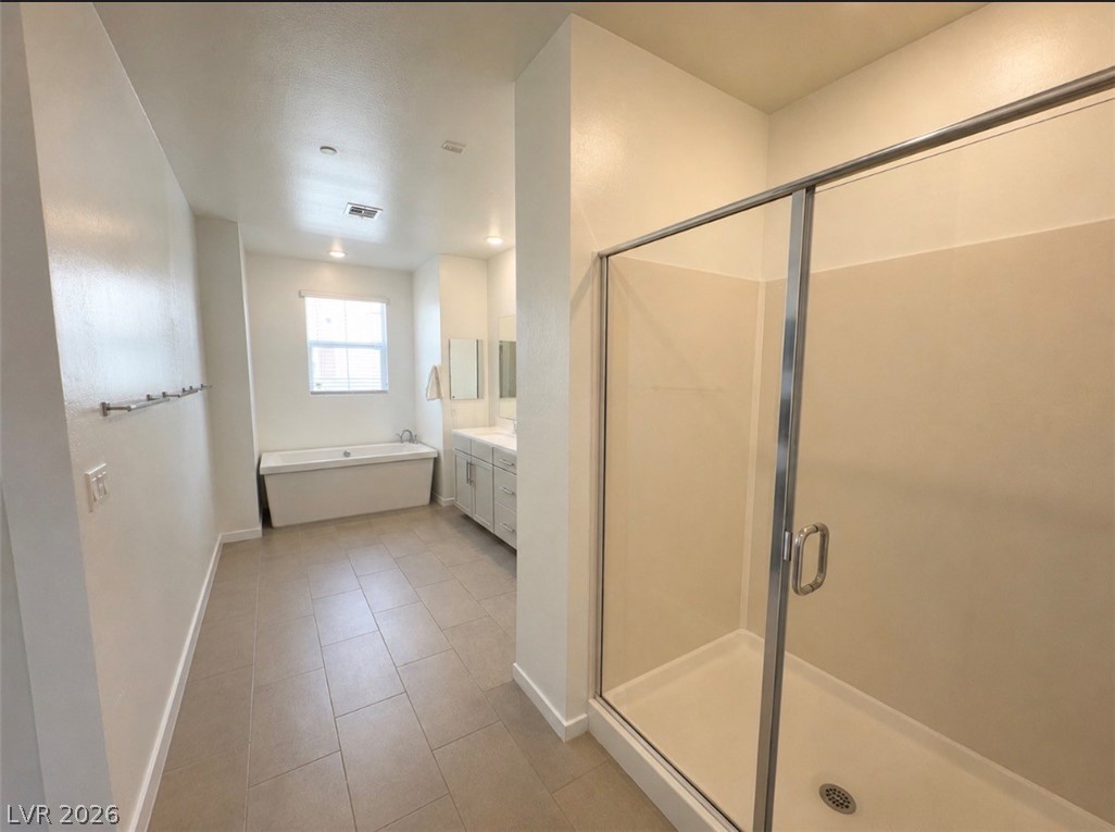2555 Hampton Road, Unit 4205 Henderson, NV 89052 - Photo 27 of 52 This primary bathroom features a generous soaking tub, dual vanity, and a glass-enclosed shower.