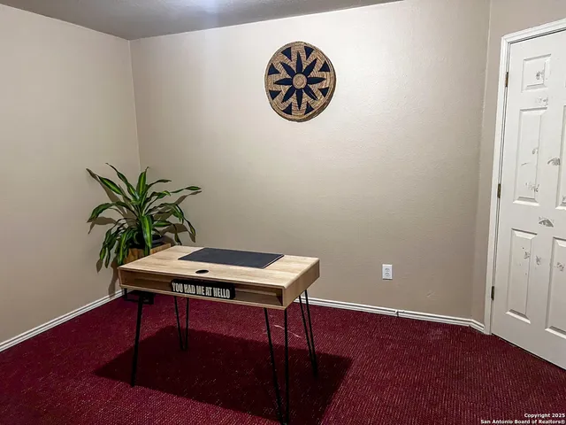 a room with a table and potted plant