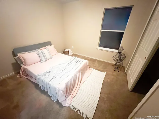 a bathroom with a sink a toilet a mirror and shower