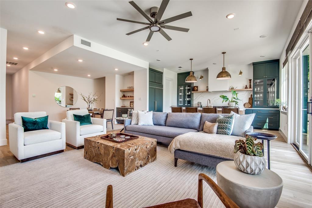 a living room with furniture kitchen view and a chandelier