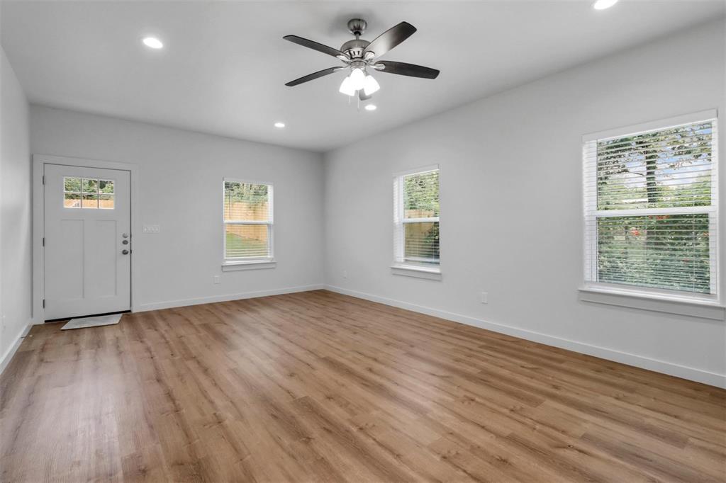 312 East Shepherd Street, Unit 312 Denison, TX 75021 - Photo 6 of 15 a view of an empty room with a window and wooden floor