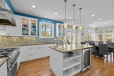 a kitchen with kitchen island granite countertop lots of counter top space and sink