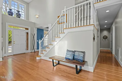a view of staircase with wooden floor and a rug