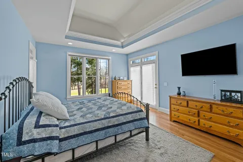 a bedroom with a bed and a flat screen television