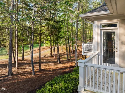 a view of a porch with a floor to ceiling window and wooden fence