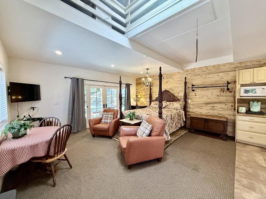 22292 Crestline Road Palomar Mountain, CA 92060 - Photo 26 of 38 a bedroom with furniture and a flat screen tv