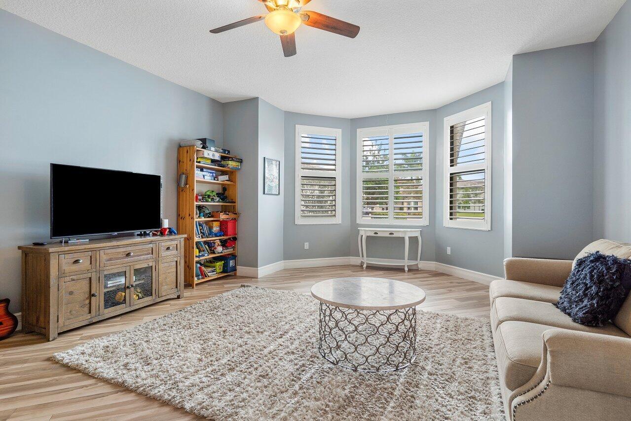 16857 Pierre Circle Delray Beach, FL 33446 - Photo 17 of 57 a living room with furniture and a flat screen tv