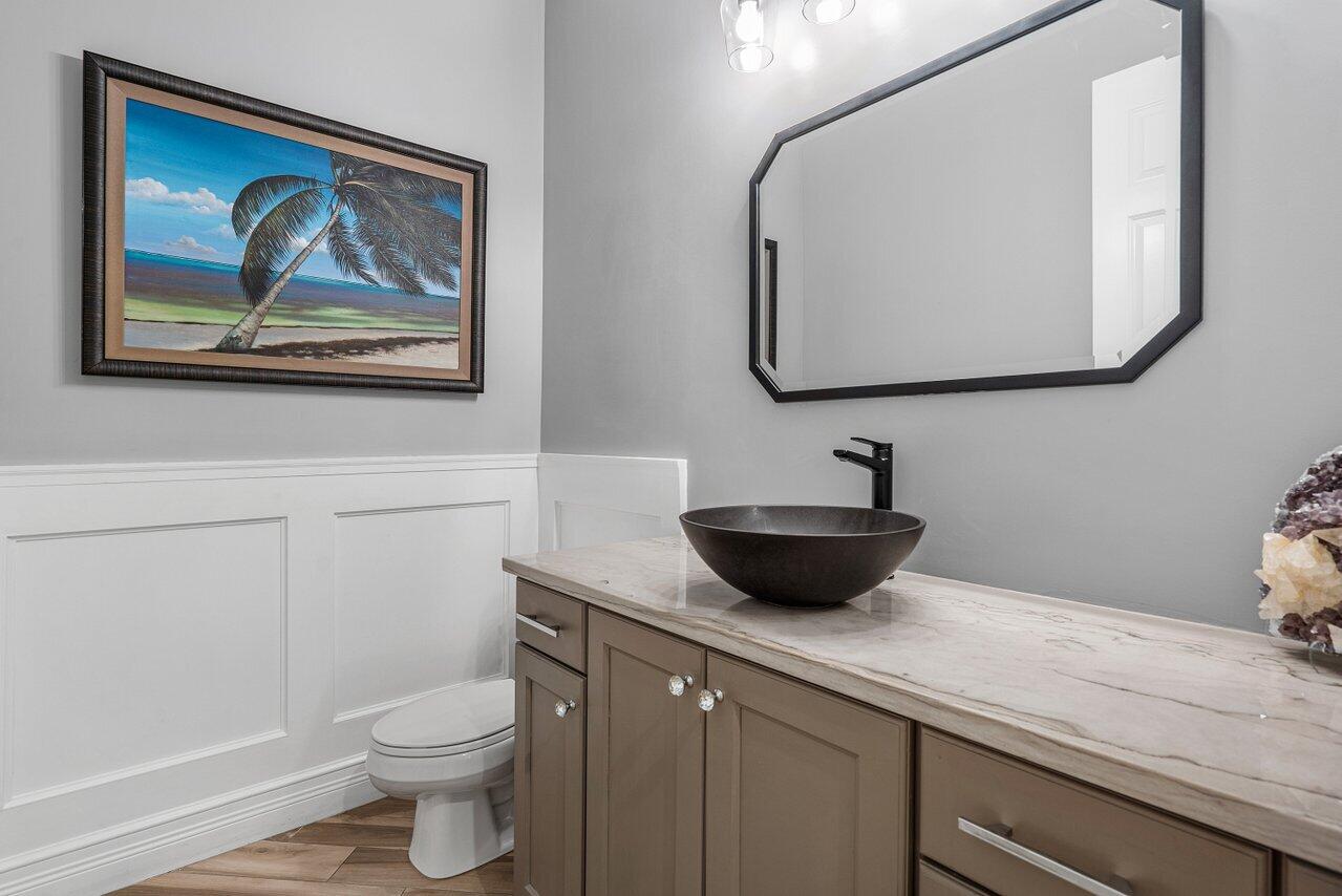 16857 Pierre Circle Delray Beach, FL 33446 - Photo 20 of 57 a bathroom with a toilet a sink and mirror