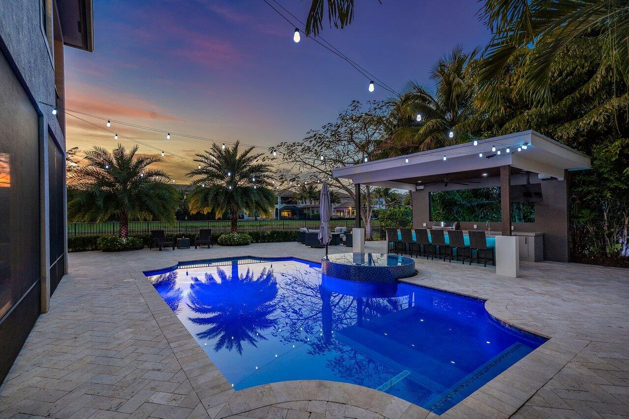 16857 Pierre Circle Delray Beach, FL 33446 - Photo 2 of 57 a view of swimming pool with seating space and palm tree