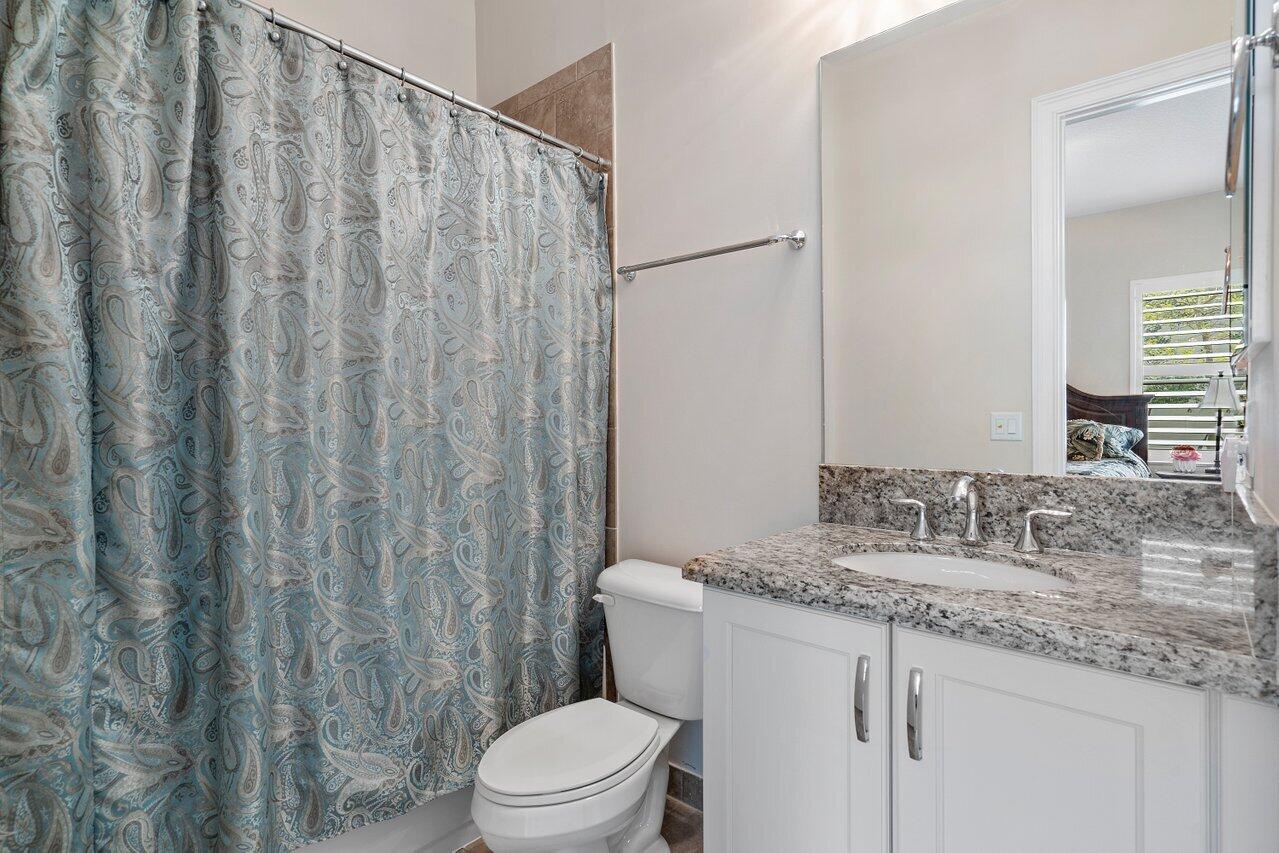 16857 Pierre Circle Delray Beach, FL 33446 - Photo 22 of 57 a bathroom with a granite countertop sink and a mirror