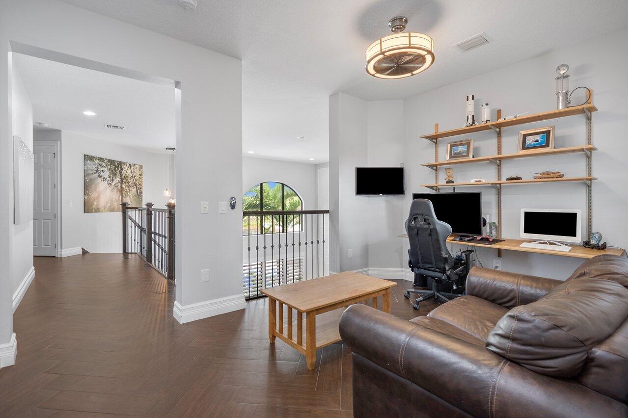16857 Pierre Circle Delray Beach, FL 33446 - Photo 29 of 57 a living room with furniture and a flat screen tv