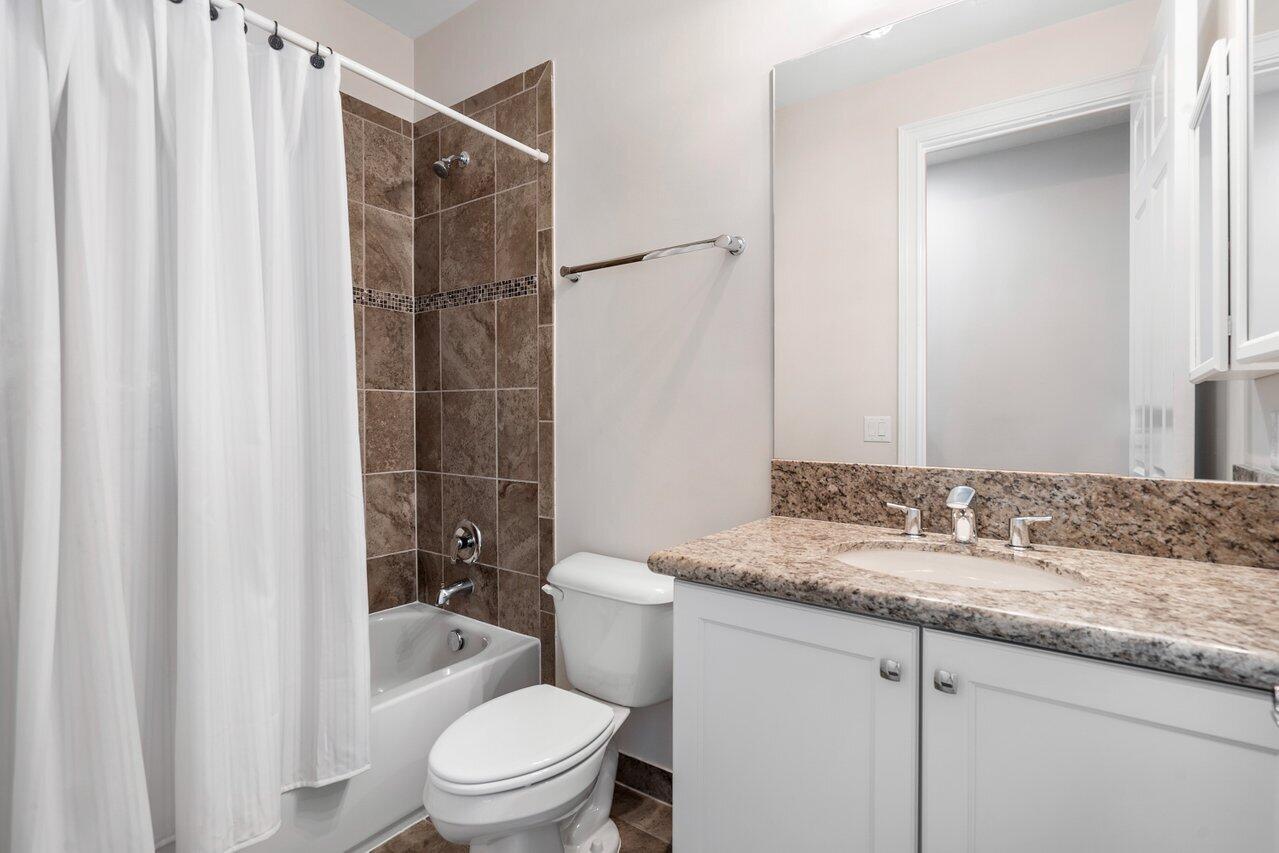 16857 Pierre Circle Delray Beach, FL 33446 - Photo 33 of 57 a bathroom with a granite countertop sink toilet and shower