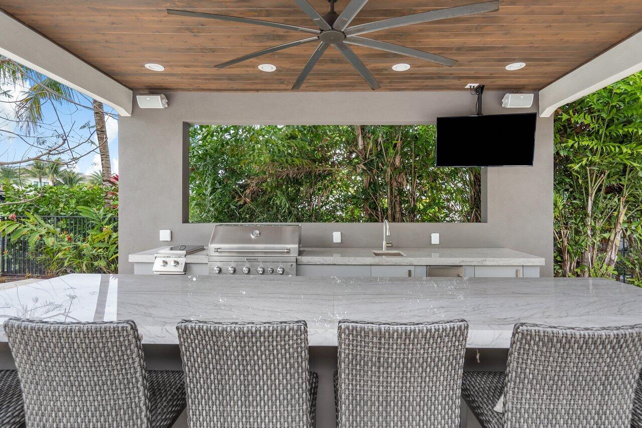 16857 Pierre Circle Delray Beach, FL 33446 - Photo 38 of 57 a roof deck with a table and chairs