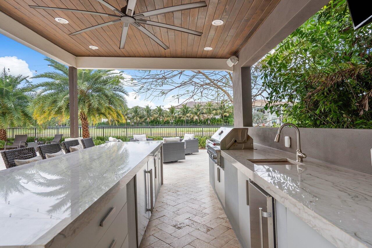 16857 Pierre Circle Delray Beach, FL 33446 - Photo 39 of 57 a spacious bathroom with a granite countertop sink and large mirror