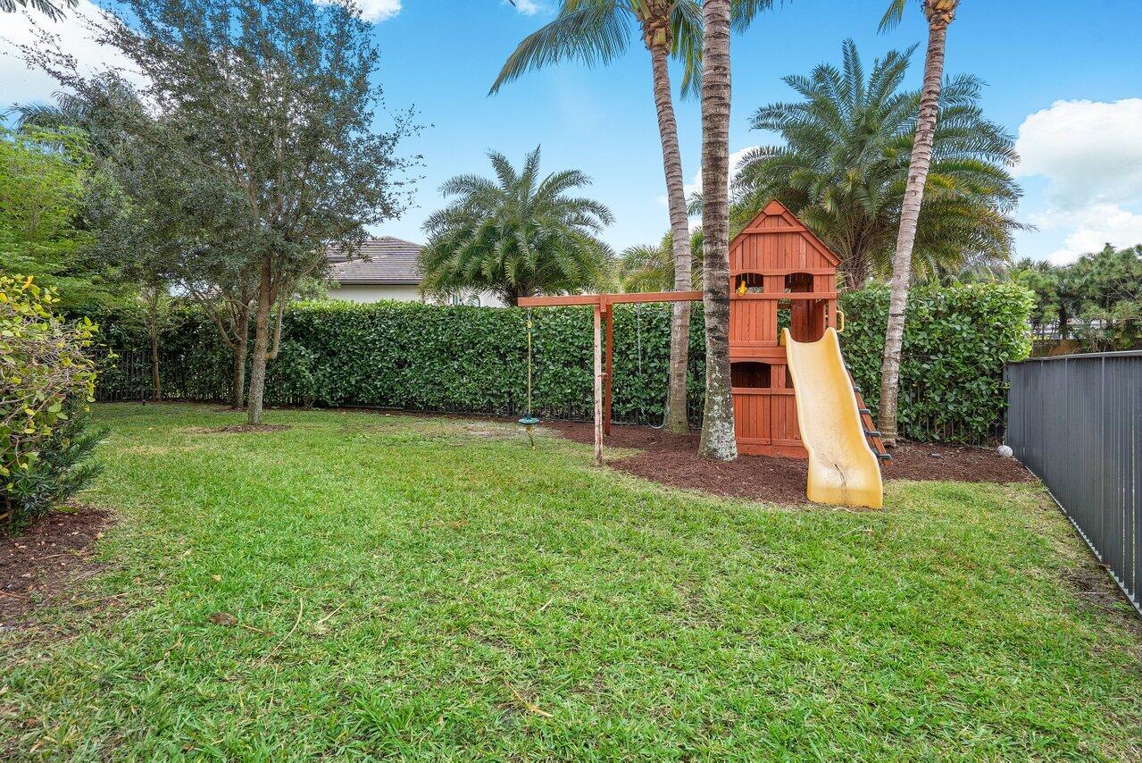16857 Pierre Circle Delray Beach, FL 33446 - Photo 42 of 57 front view of house with a yard and potted plants