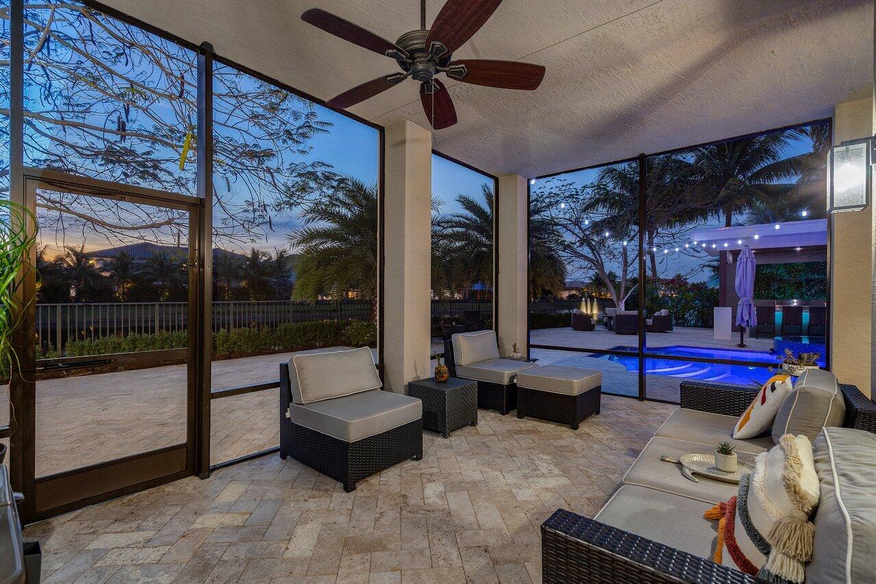 16857 Pierre Circle Delray Beach, FL 33446 - Photo 51 of 57 a living room with patio furniture and a floor to ceiling window