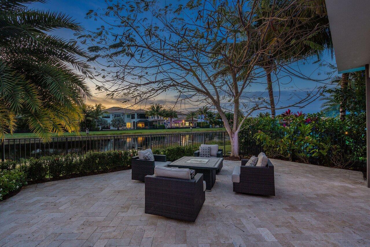 16857 Pierre Circle Delray Beach, FL 33446 - Photo 54 of 57 a view of a patio with couches chairs and a fire pit
