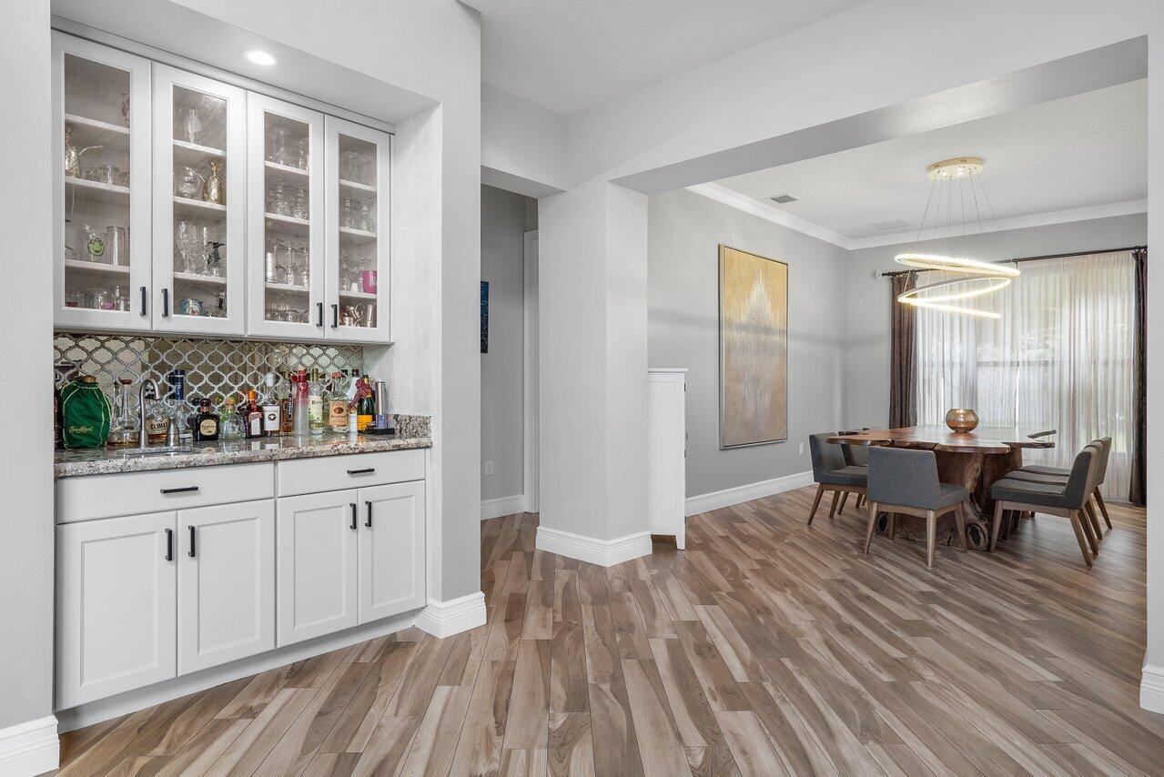 16857 Pierre Circle Delray Beach, FL 33446 - Photo 9 of 57 a view of a dining room with furniture and chandelier
