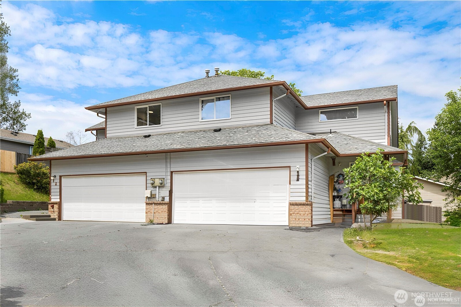 a front view of a house with a yard and garage