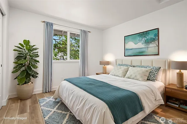 a bedroom with a bed and a painting on the wall