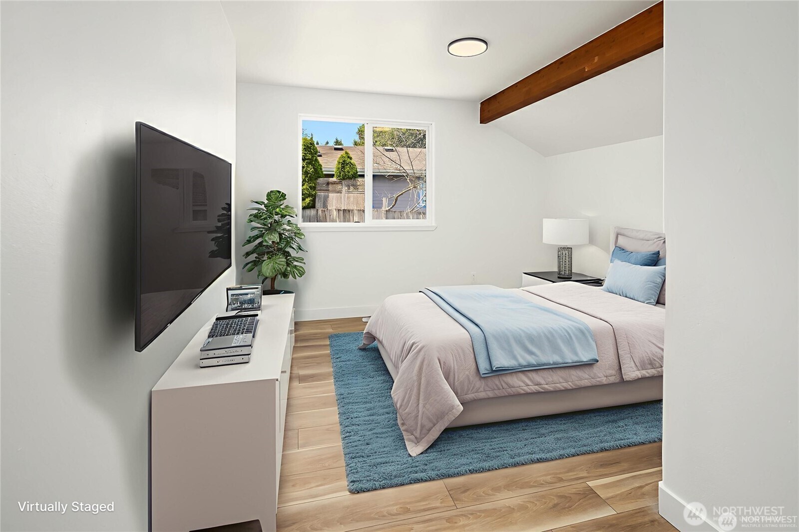 9 76th Street Southeast Everett, WA 98203 - Photo 21 of 28 a bedroom with a flat screen tv a lamp and a bed