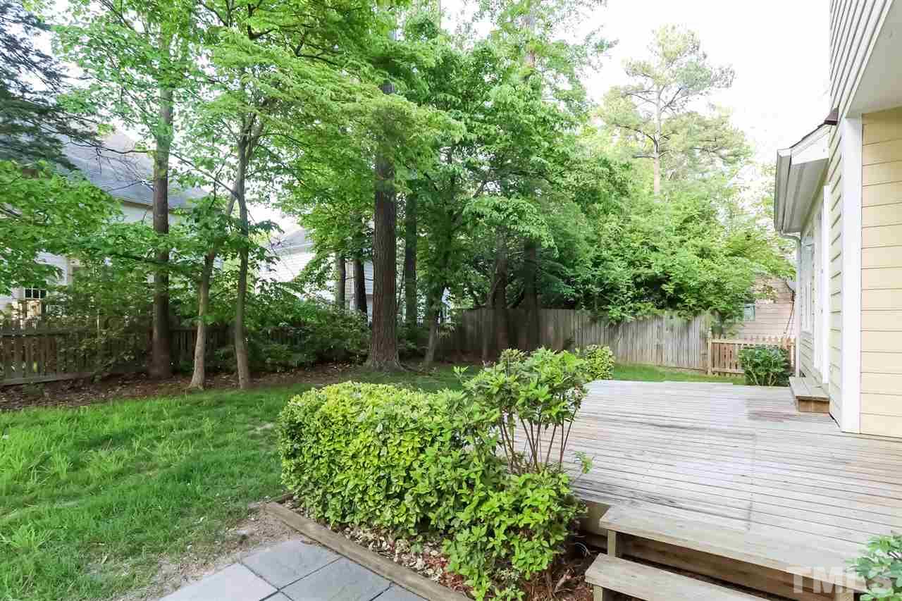 2357 Declaration Drive Raleigh, NC 27615 - Photo 22 of 24 a view of a backyard with potted plants and large trees