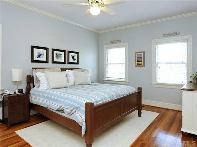 512 Chesterfield Road Raleigh, NC 27608 - Photo 14 of 25 a bed sitting in a bedroom next to a window