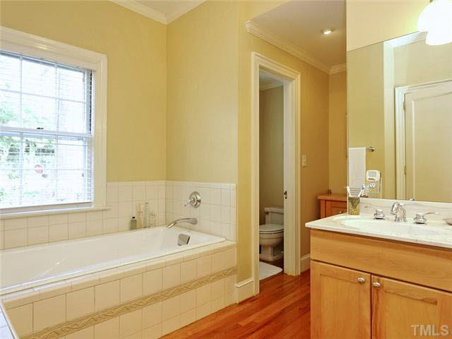 512 Chesterfield Road Raleigh, NC 27608 - Photo 16 of 25 a bathroom with a tub sink and a mirror