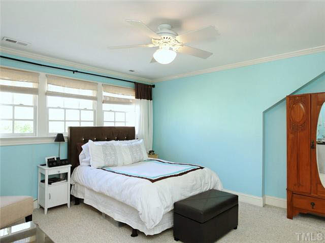 512 Chesterfield Road Raleigh, NC 27608 - Photo 18 of 25 a bedroom with a bed and a chandelier