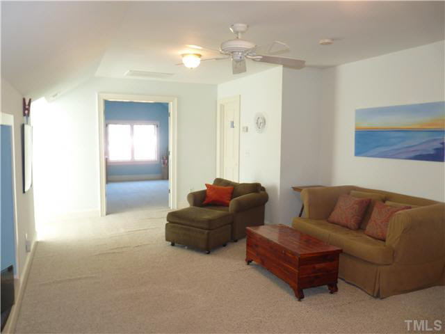 512 Chesterfield Road Raleigh, NC 27608 - Photo 21 of 25 a living room with furniture and a chandelier