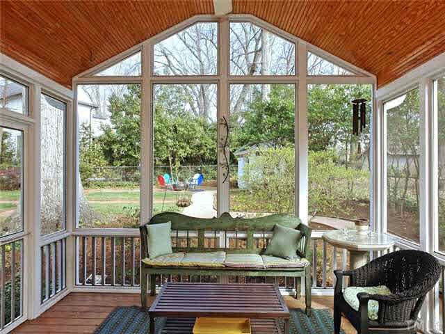 512 Chesterfield Road Raleigh, NC 27608 - Photo 22 of 25 a living room with large windows and wooden floor