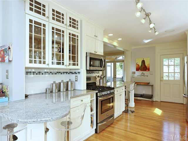512 Chesterfield Road Raleigh, NC 27608 - Photo 23 of 25 a kitchen with stainless steel appliances granite countertop a stove and cabinets
