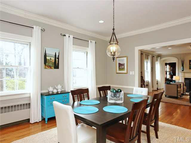 512 Chesterfield Road Raleigh, NC 27608 - Photo 5 of 25 a dining room with furniture a chandelier and wooden floor