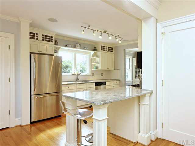 512 Chesterfield Road Raleigh, NC 27608 - Photo 9 of 25 a kitchen with kitchen island a counter top space and stainless steel appliances