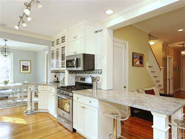 512 Chesterfield Road Raleigh, NC 27608 - Photo 10 of 25 a kitchen with stainless steel appliances kitchen island granite countertop a stove and cabinets