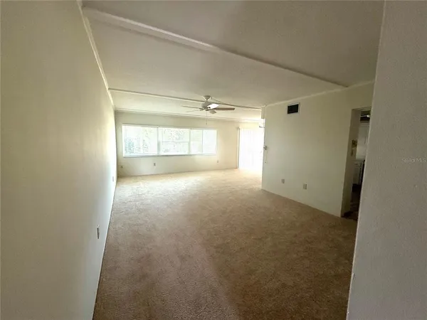 a view of an empty room with a window