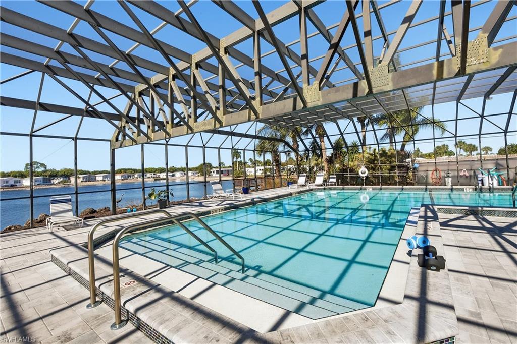 26 Bass Lane Naples, FL 34114 - Photo 18 of 26 Community pool featuring a patio and a lanai