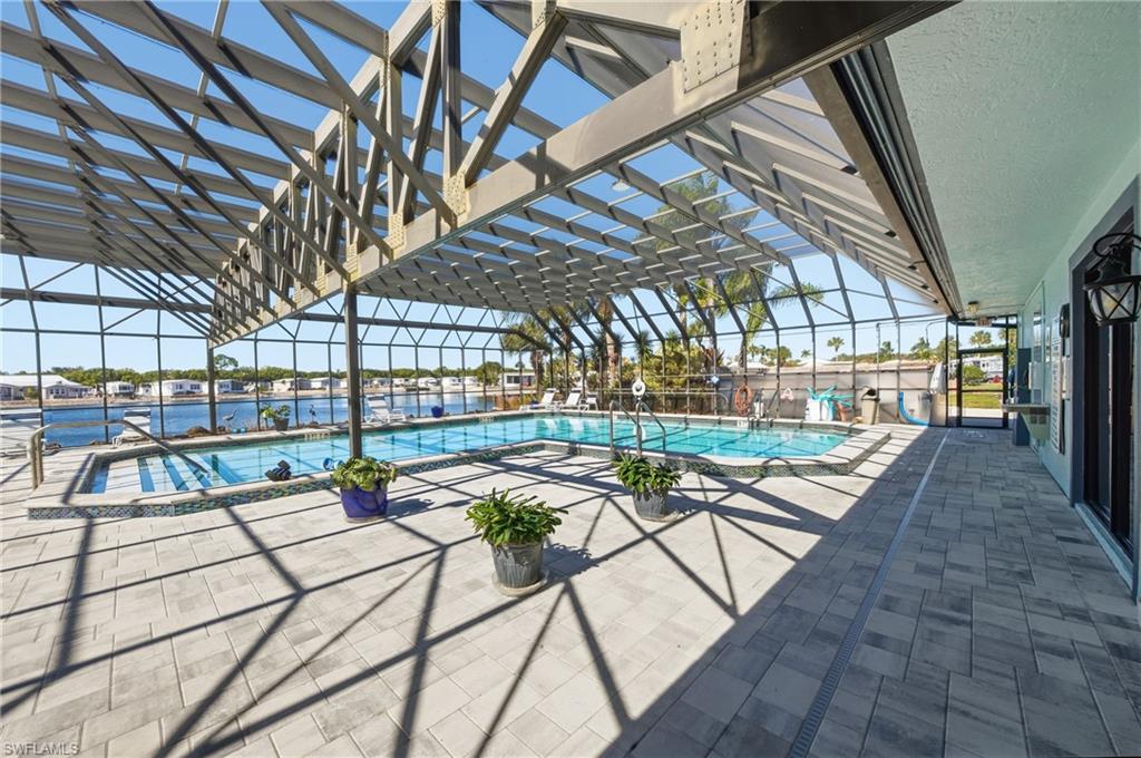26 Bass Lane Naples, FL 34114 - Photo 20 of 26 Community pool featuring a patio area and a sunroom