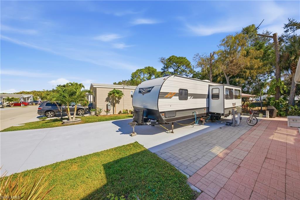 26 Bass Lane Naples, FL 34114 - Photo 10 of 26 View of front facade featuring a front yard