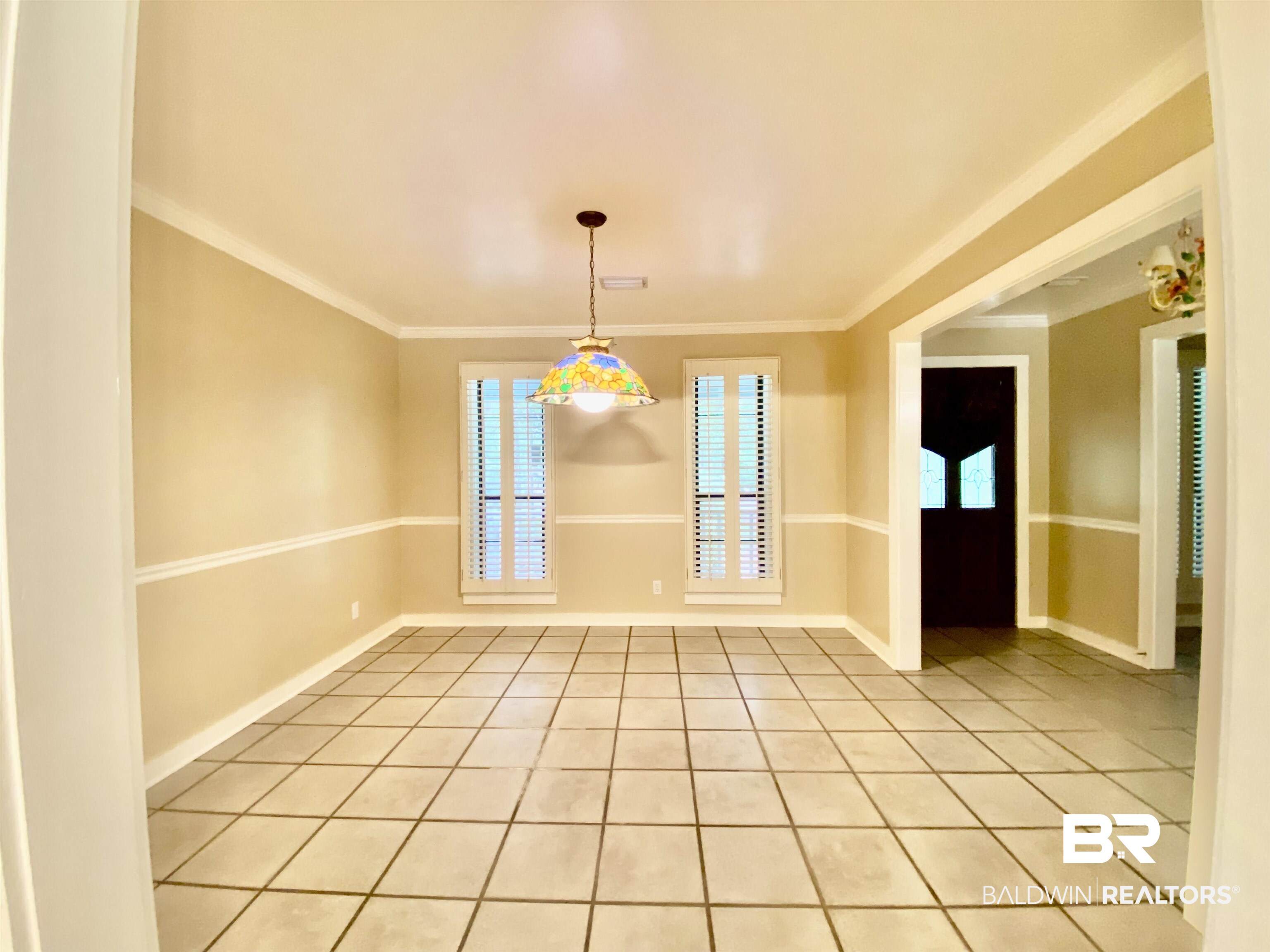 160 Mockingbird Lane Monroeville, AL 36460 - Photo 7 of 36 Empty room featuring light tile patterned flooring and crown molding