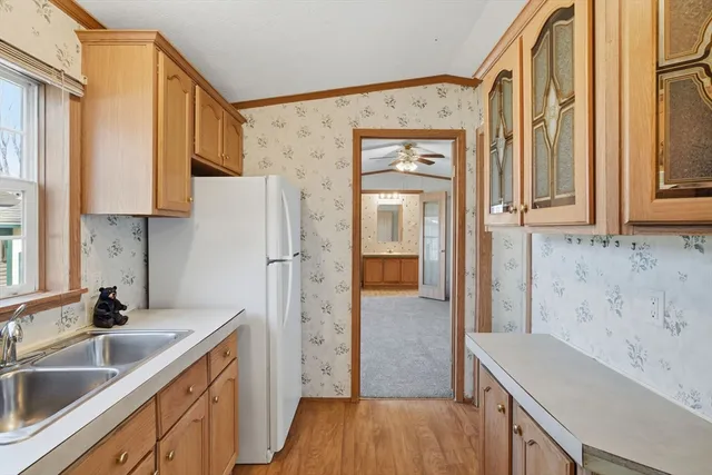 a kitchen with stainless steel appliances granite countertop a refrigerator and a sink