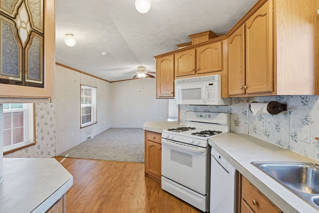 15 Quaboag Valley, Unit 15 Sudbury, MA 01776 - Photo 14 of 35 a kitchen with granite countertop a sink stove and cabinets