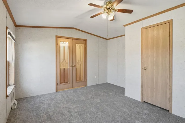 an empty room with windows and closet