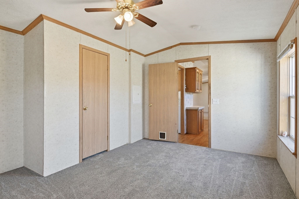15 Quaboag Valley, Unit 15 Sudbury, MA 01776 - Photo 20 of 35 a view of a room with a chandelier fan and a window