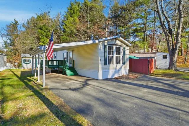 a view of a house with a yard and tree s