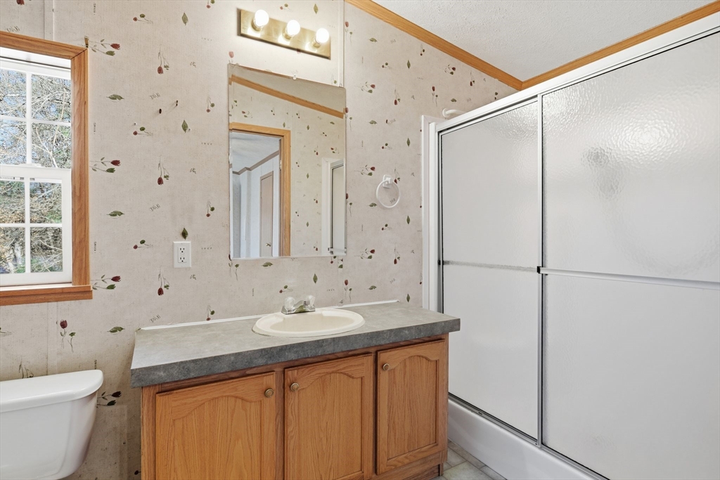 15 Quaboag Valley, Unit 15 Sudbury, MA 01776 - Photo 21 of 35 a bathroom with a double vanity sink mirror and double