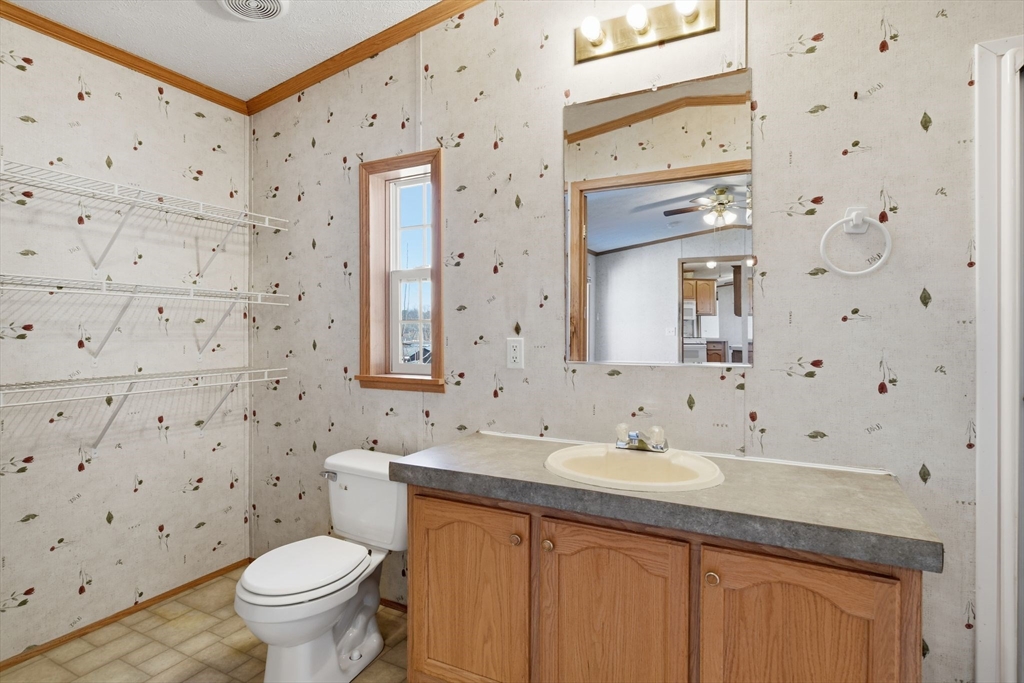 15 Quaboag Valley, Unit 15 Sudbury, MA 01776 - Photo 22 of 35 a bathroom with a granite countertop sink a toilet and a mirror